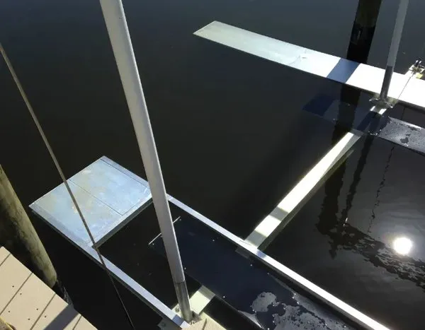 Close-up of aluminum plates installed on a boat lift for secure dockside access and stability.