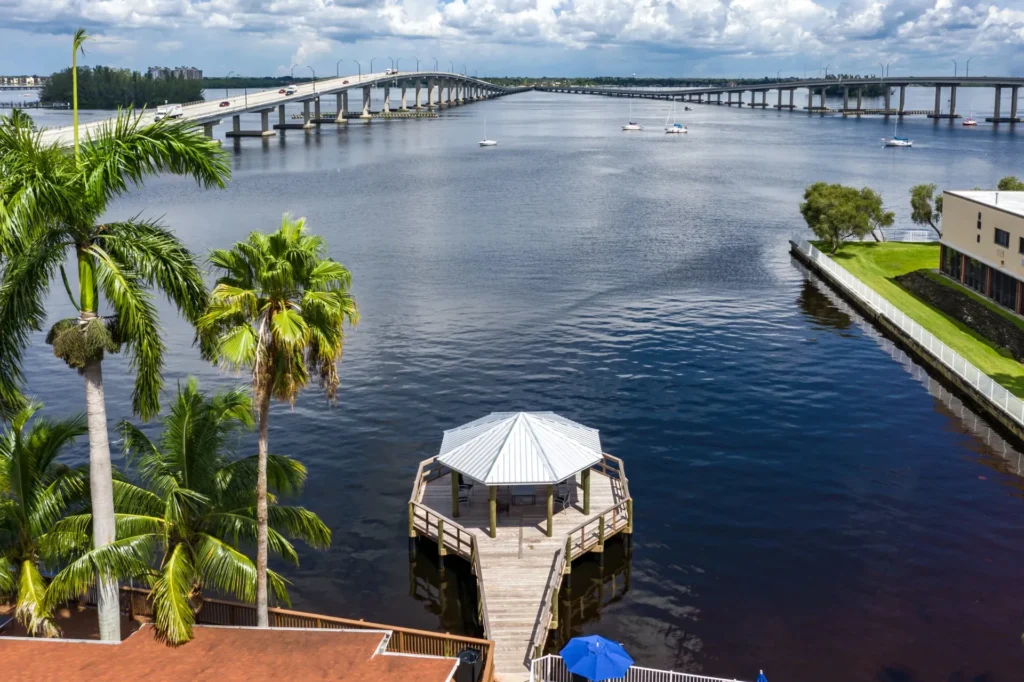 A boathouse on the Caloosahatchee River with a covered dock and scenic water views.