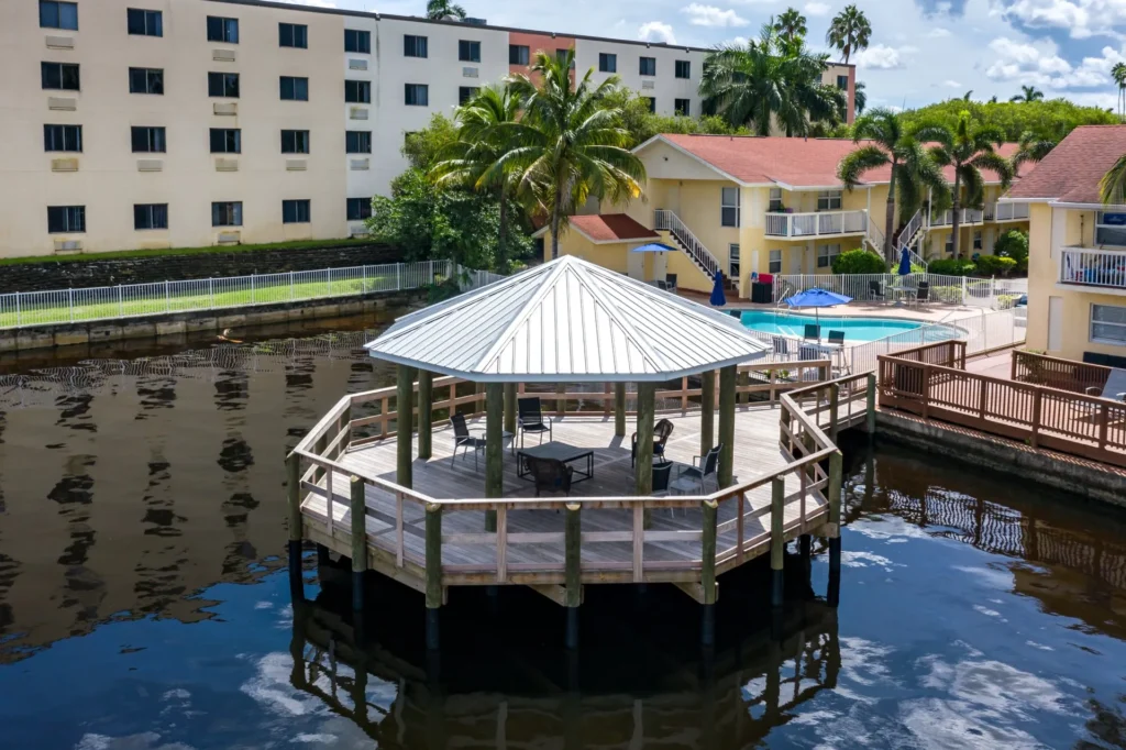 A modern boathouse with durable construction, featuring a sturdy dock system and roof for seamless waterfront access.