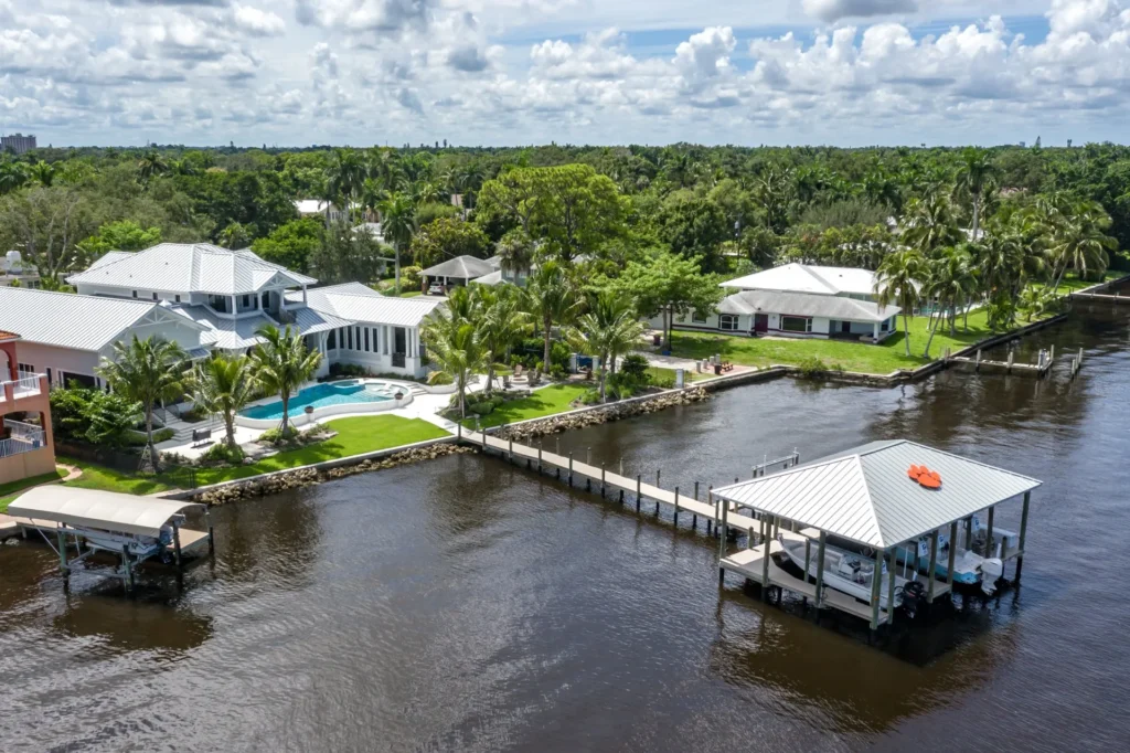 A luxury waterfront dock and boathouse featuring premium materials, a sleek design, and a covered storage area for boats.