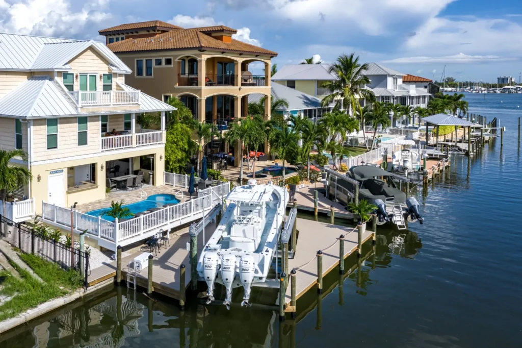 A waterfront dock designed to accommodate a large boat with three motors, featuring durable construction and ample space.