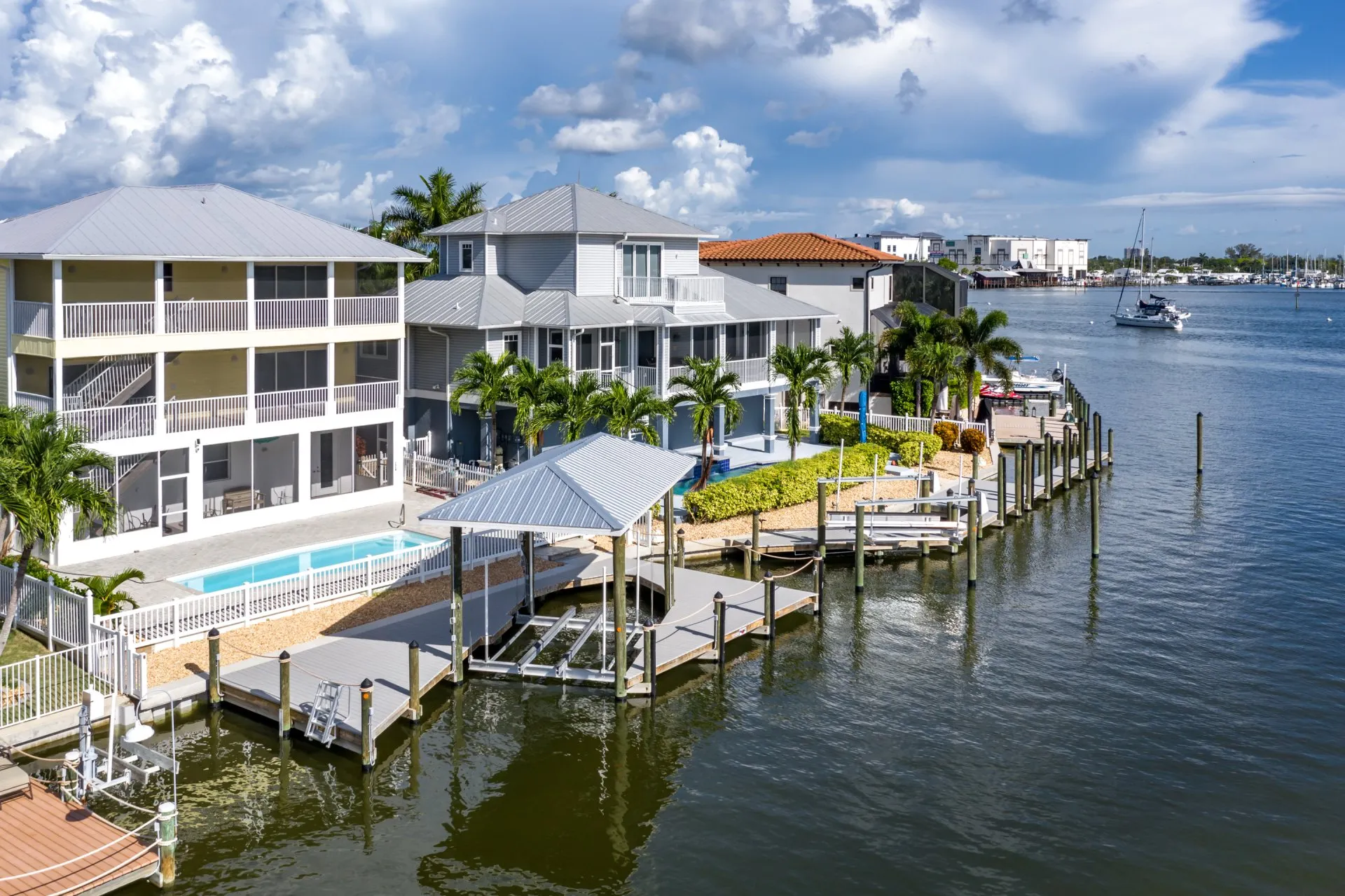 A stunning waterfront property with private docks, a covered boat lift, and a swimming pool.